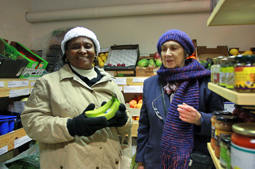 Nioka and Judy looking at bananas in a greengrocery