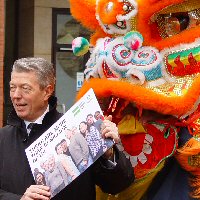 Alan Johnson receiving the petition from a Chinese dragon